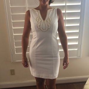 Stun in this beaded white Lilly